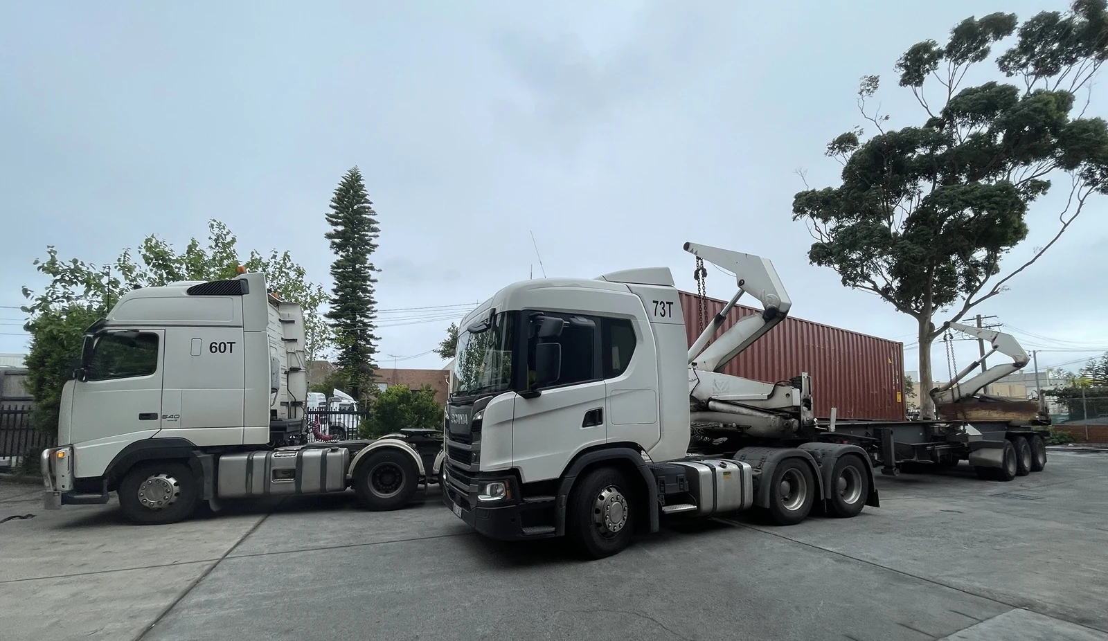 Two container transport trucks used for a bonded zone same-day round trip