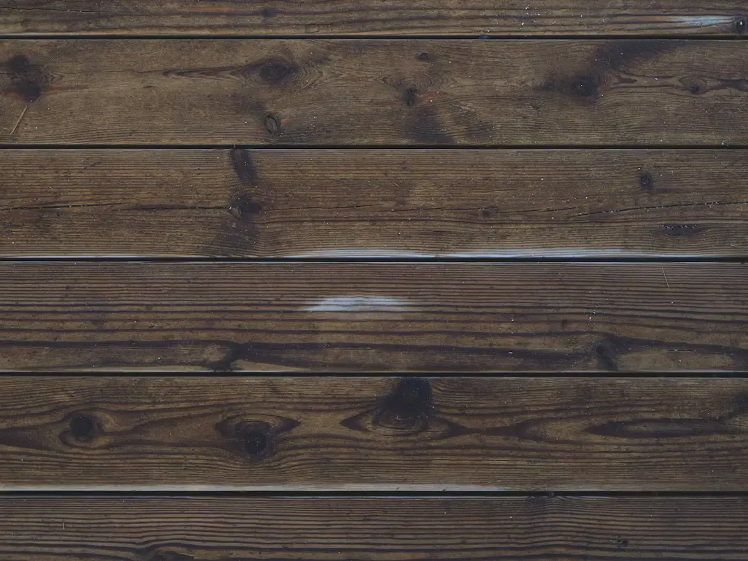 Dark stained solid wood boards with visible grain